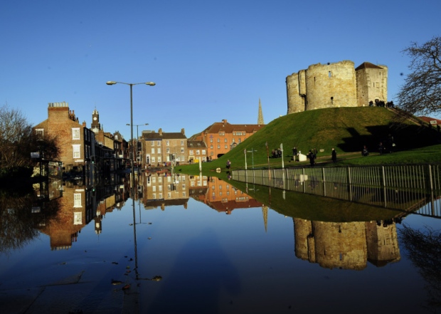 Clifford's Tower, once part of York Castle, in York, which sits between the River Ouse and River Foss, is reflected in floodwater after the rivers burst their banks.